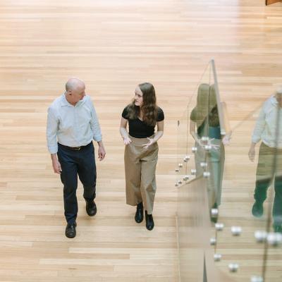 student and lecturer walking together and talking