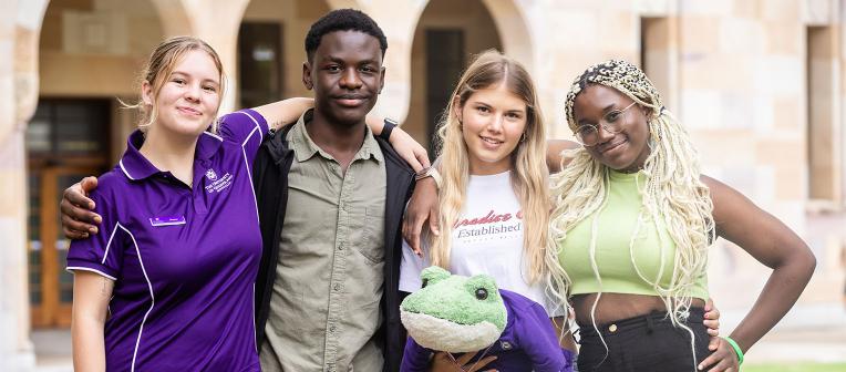 4 young achievers with arms around each other in the Great Court